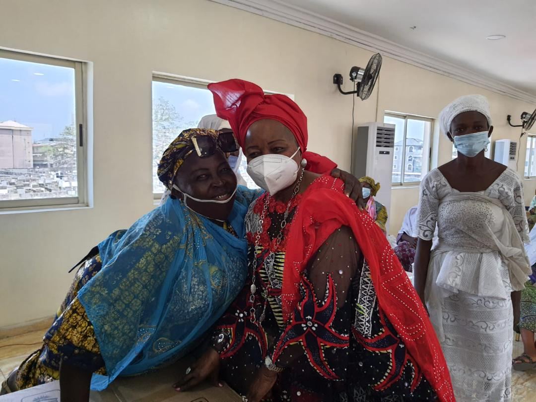 Two women embracing warmly at a Matriarch Foundation program
